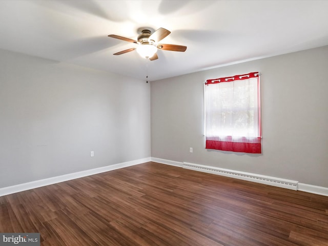 spare room with dark wood-type flooring, ceiling fan, and a baseboard heating unit