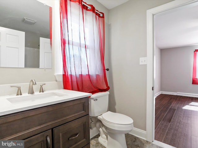 bathroom featuring vanity, hardwood / wood-style floors, and toilet