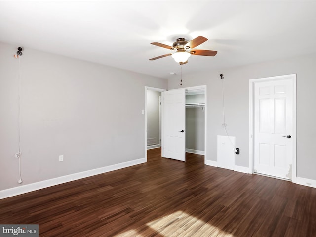 unfurnished bedroom with a closet, dark hardwood / wood-style floors, and ceiling fan