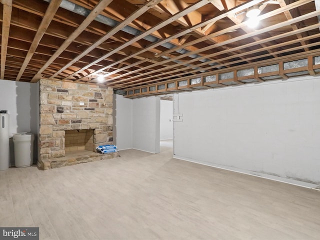 basement featuring hardwood / wood-style flooring and a fireplace