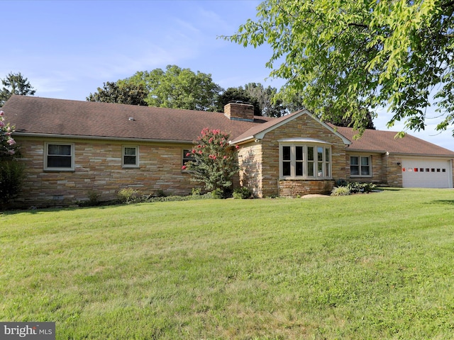 view of front facade with a garage and a front lawn