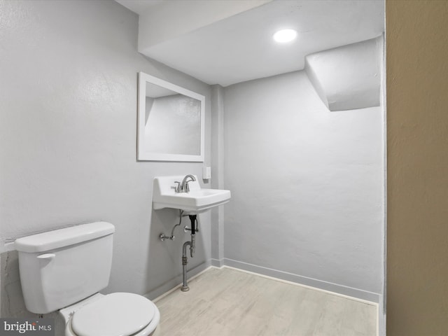 bathroom with wood-type flooring and toilet