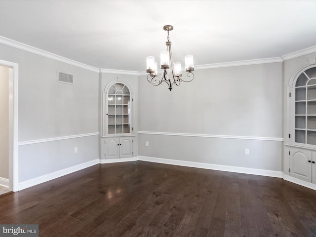 unfurnished dining area with dark wood-type flooring, ornamental molding, and a chandelier