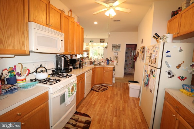 kitchen featuring ceiling fan, light wood-type flooring, sink, and white appliances