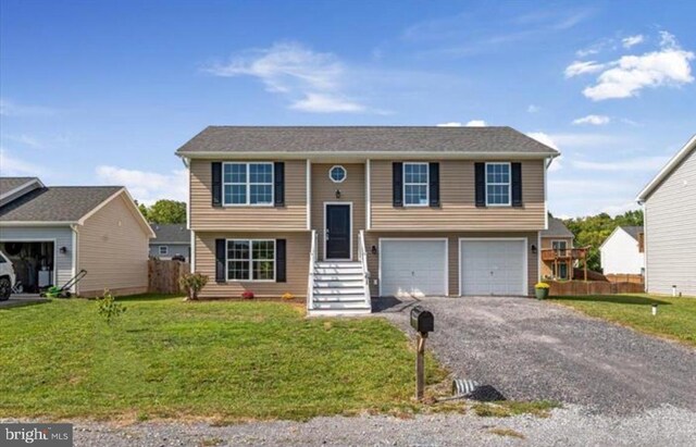 bi-level home with a garage and a front yard