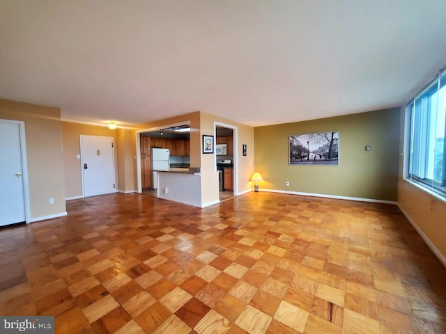 unfurnished living room featuring light parquet floors