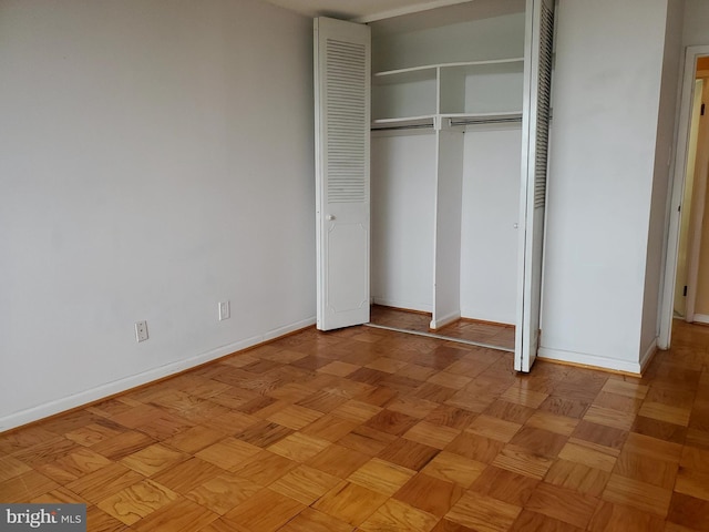 unfurnished bedroom with light parquet flooring