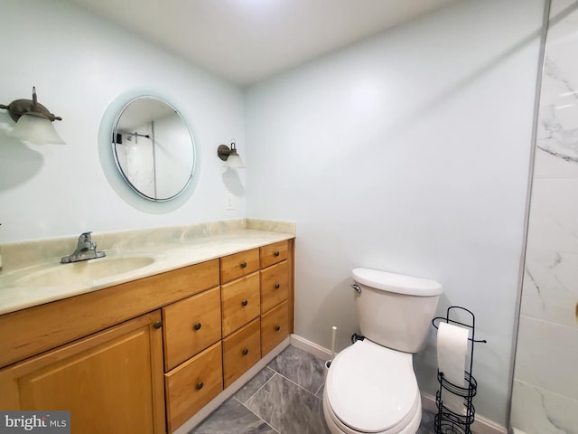 bathroom featuring toilet, vanity, and tile patterned flooring