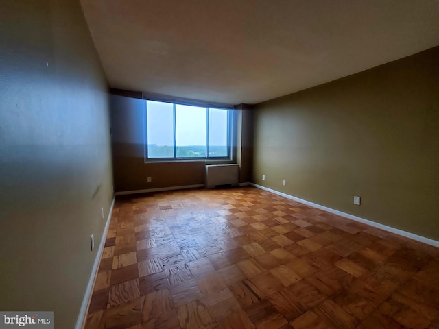 empty room with parquet flooring