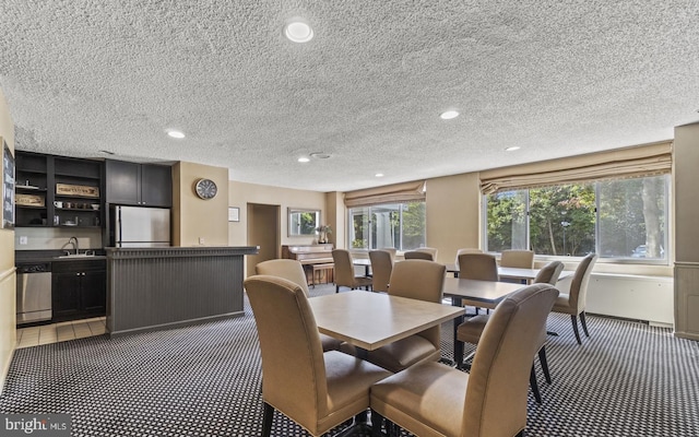 dining room featuring sink and a textured ceiling