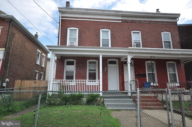 view of front of property featuring a porch and cooling unit