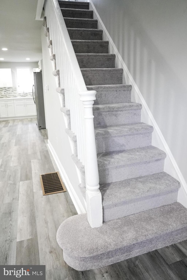 staircase featuring hardwood / wood-style flooring