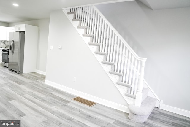 stairway featuring light hardwood / wood-style floors