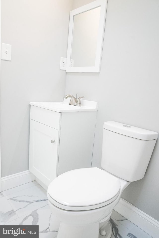 bathroom with tile patterned floors, toilet, and vanity