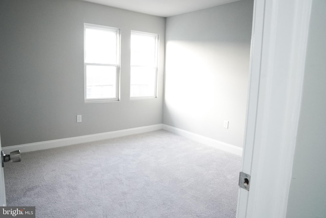 carpeted spare room with a wealth of natural light