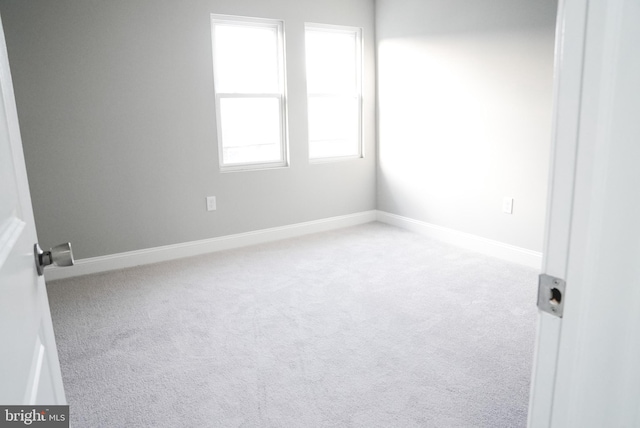 unfurnished room with light carpet