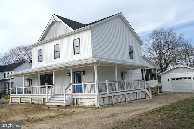 view of front of house with an outdoor structure, a garage, covered porch, and driveway