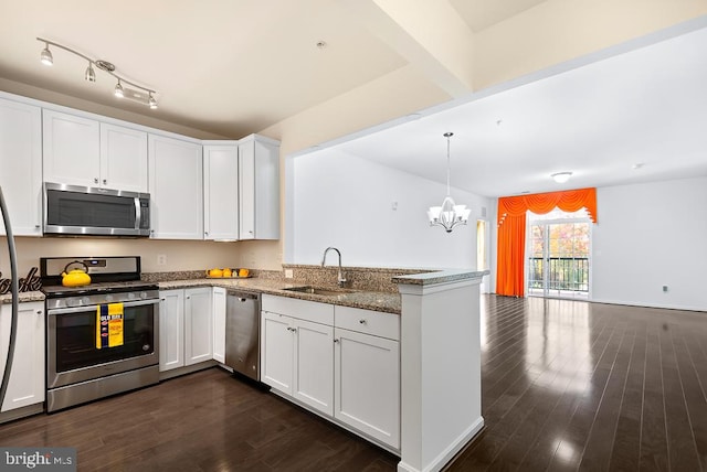 kitchen featuring kitchen peninsula, white cabinets, dark hardwood / wood-style flooring, appliances with stainless steel finishes, and sink