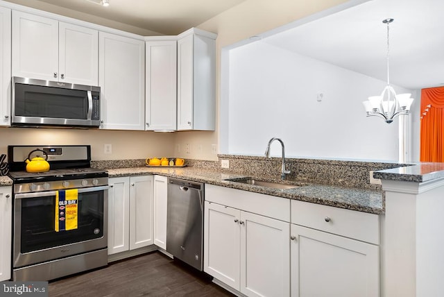 kitchen with sink, appliances with stainless steel finishes, white cabinetry, and dark hardwood / wood-style flooring