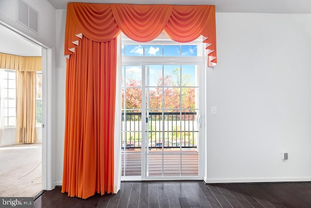 doorway to outside featuring dark wood-type flooring