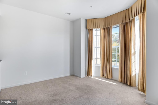 spare room with light colored carpet