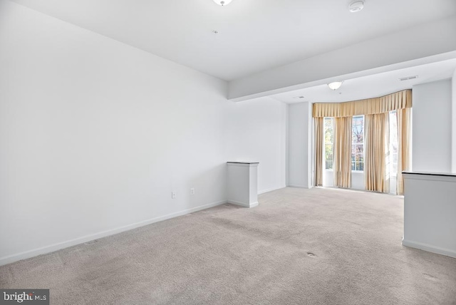 unfurnished living room featuring light carpet