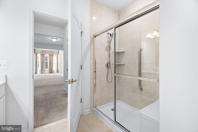 bathroom with vanity, an enclosed shower, and tile patterned flooring