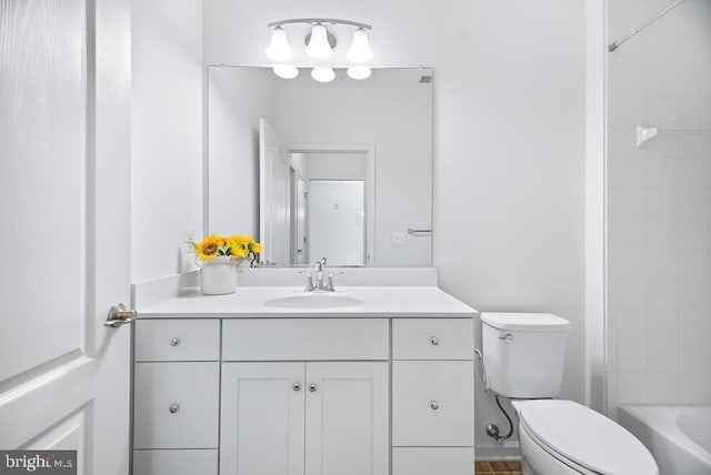 full bathroom featuring toilet, tiled shower / bath, and vanity