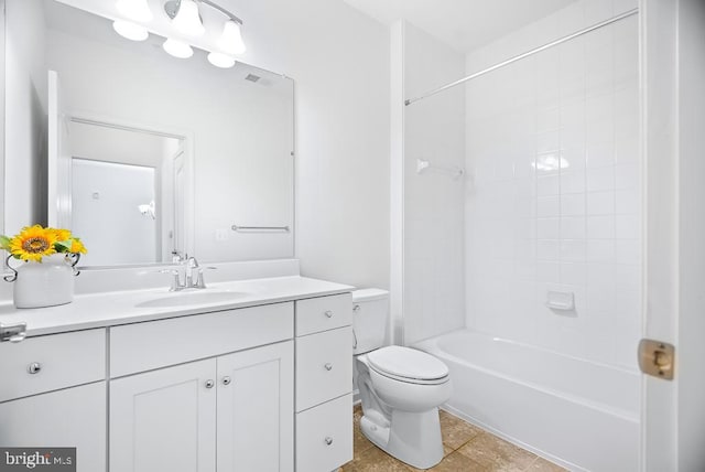 full bathroom featuring toilet, tiled shower / bath combo, vanity, and tile patterned floors