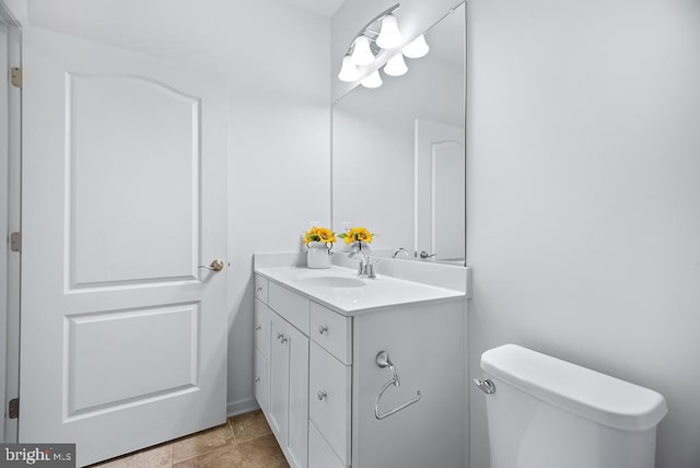 bathroom featuring vanity, toilet, and tile patterned flooring