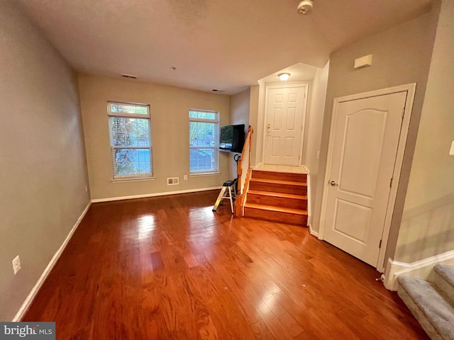 unfurnished living room with hardwood / wood-style floors