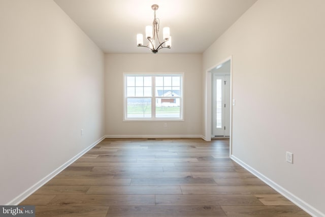 interior space with a chandelier and hardwood / wood-style flooring