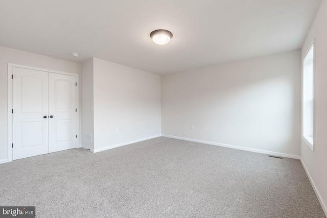 carpeted empty room featuring a wealth of natural light