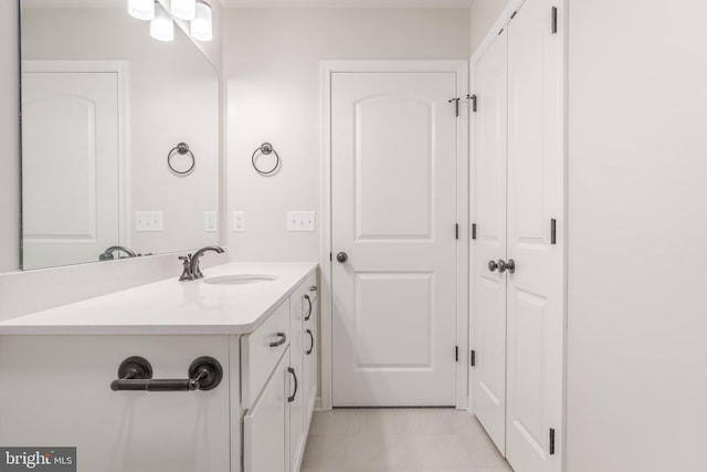 bathroom with tile patterned flooring and vanity