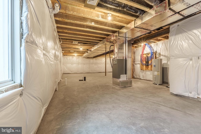 basement featuring water heater and heating unit