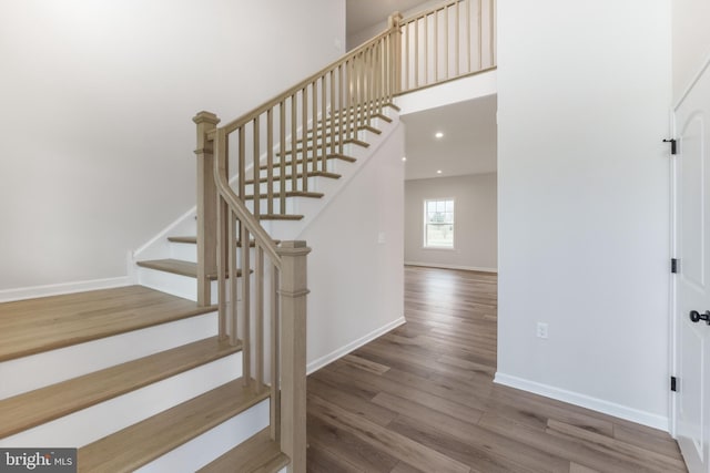 stairs featuring hardwood / wood-style flooring