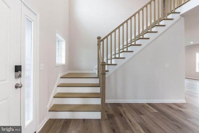 stairway with hardwood / wood-style floors