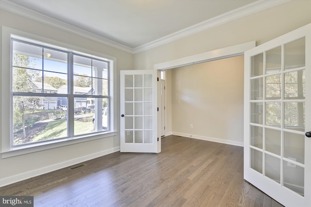 unfurnished room with hardwood / wood-style floors, french doors, and crown molding