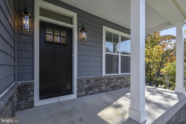 view of exterior entry featuring a porch