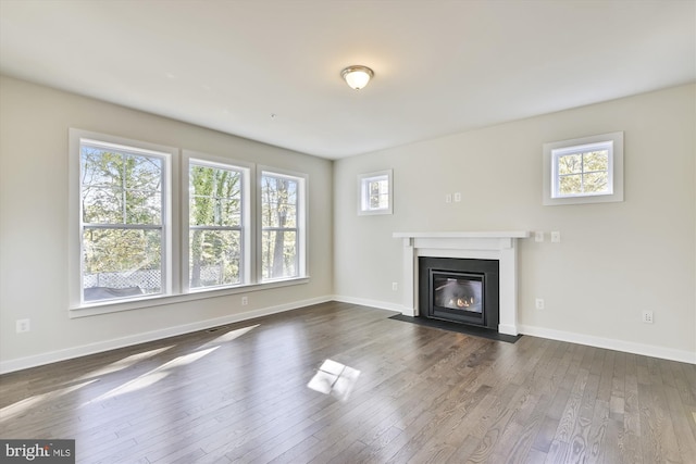 unfurnished living room with dark hardwood / wood-style floors