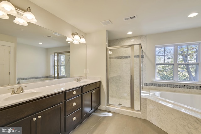 bathroom featuring vanity, shower with separate bathtub, and a healthy amount of sunlight