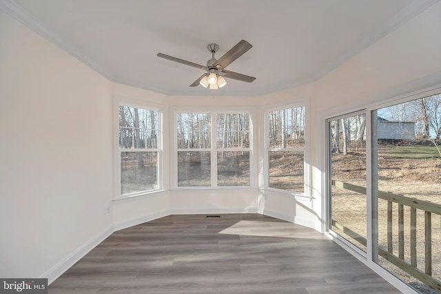 unfurnished sunroom featuring ceiling fan