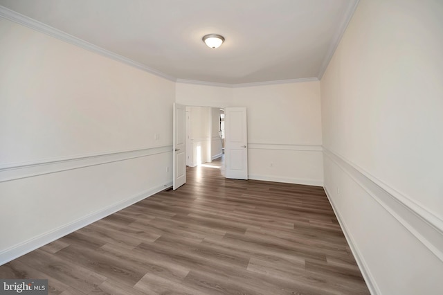 unfurnished room featuring dark hardwood / wood-style flooring and crown molding