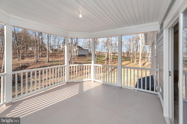 unfurnished sunroom with wooden ceiling