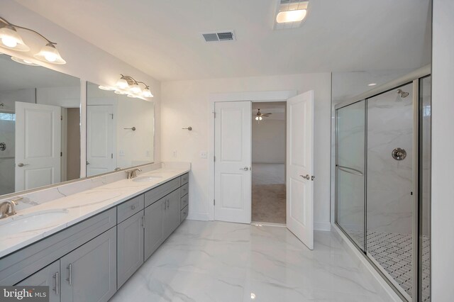 bathroom with ceiling fan, a shower with shower door, and vanity