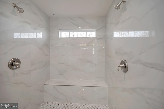 bathroom with tiled shower