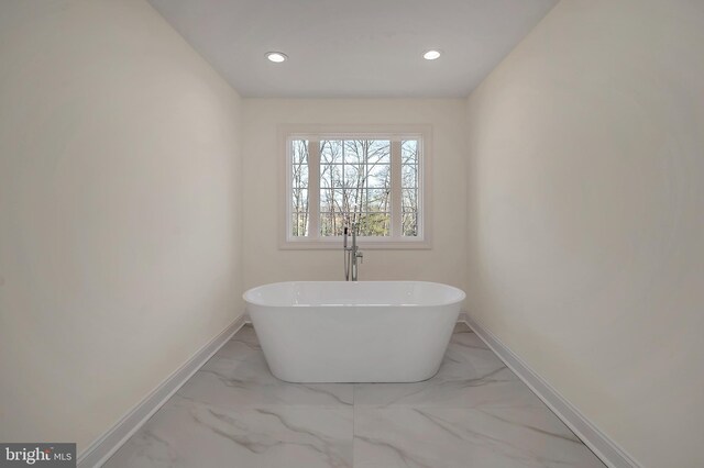 bathroom with a tub to relax in