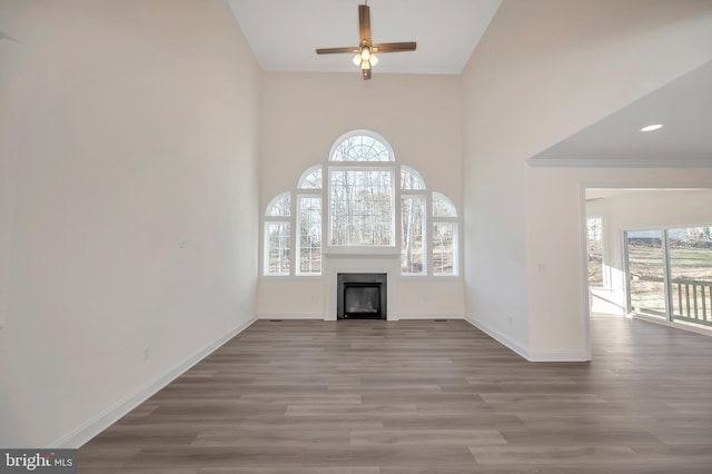 unfurnished living room with ceiling fan and light hardwood / wood-style floors