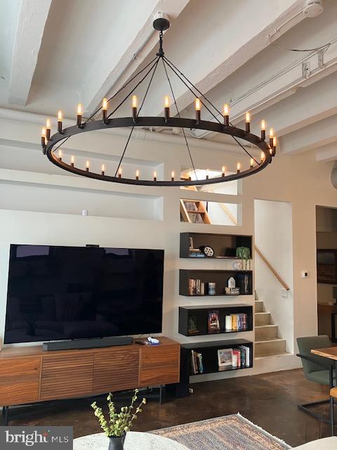 living room featuring concrete flooring and beam ceiling