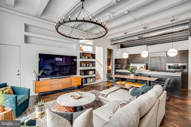 living room featuring a high ceiling, built in features, and sink